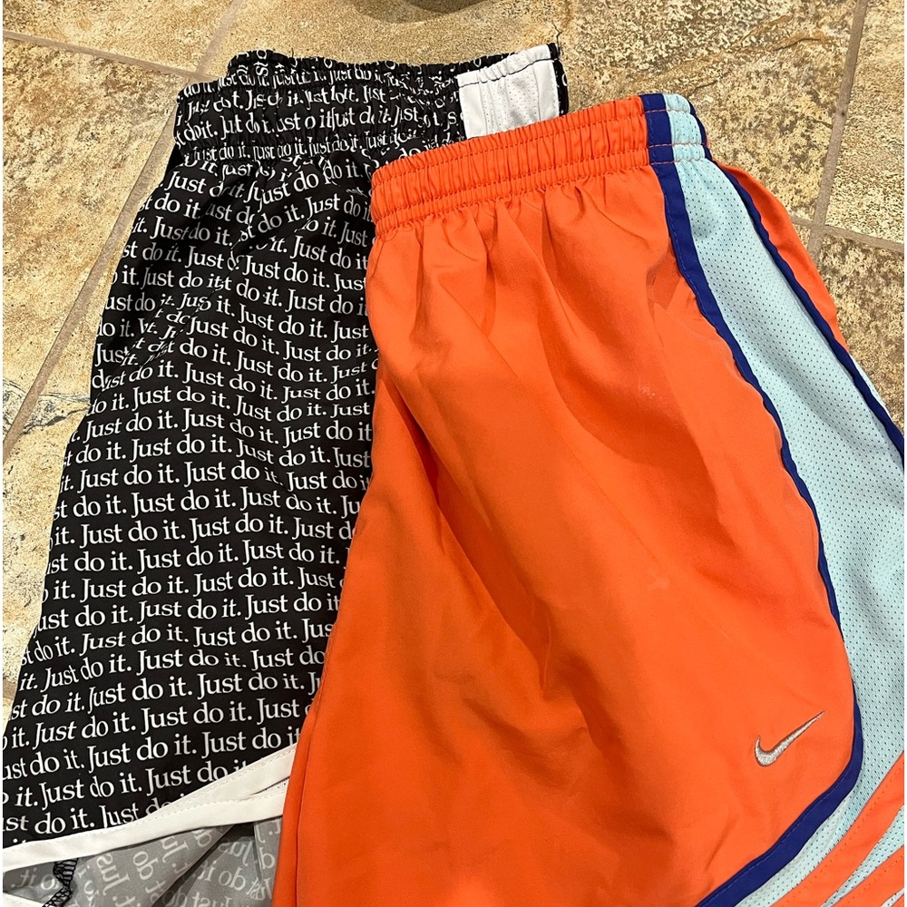 Two pairs of Nike athletic shorts. Both medium